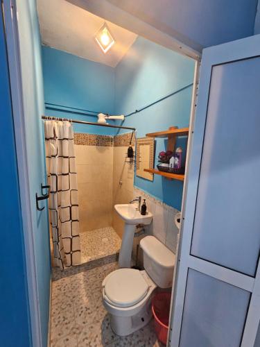 a small bathroom with a toilet and a sink at LOS SAUCES STUDIO in Puerto Vallarta