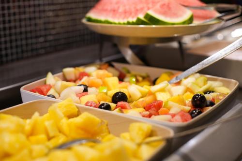 a buffet of fruit in trays on a table at Radisson Blu Hotel Dortmund in Dortmund