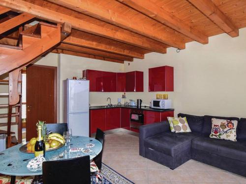 a kitchen and a living room with a table and a couch at Soffio Di Rugiada in Fonteno