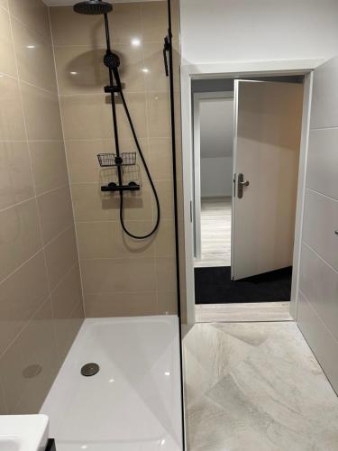 a bathroom with a shower with a glass door at FeWo Max in Freudenburg