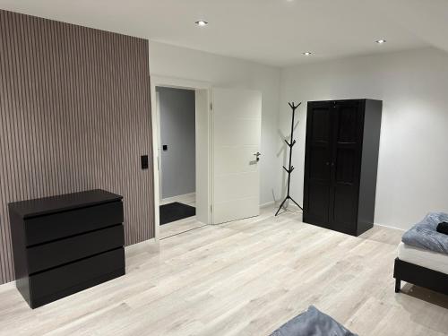 a bedroom with a bed and a dresser and a hallway at FeWo Max in Freudenburg