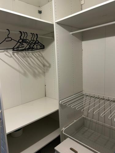 a walk in closet with white cabinets and a drawer at LE JULA - APPARTEMENT T2 PROCHE CENTRE VILLE - Parking privé in Albi
