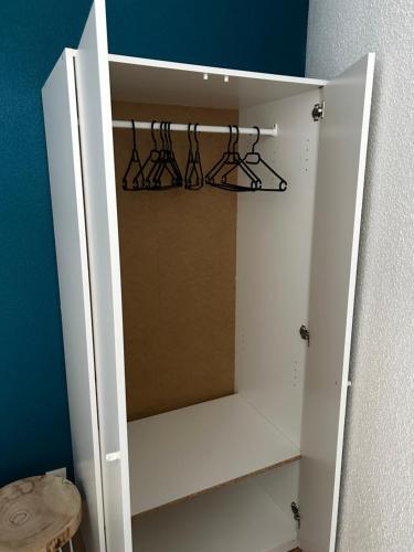 a white cabinet with three wine racks in it at LE JULA - APPARTEMENT T2 PROCHE CENTRE VILLE - Parking privé in Albi