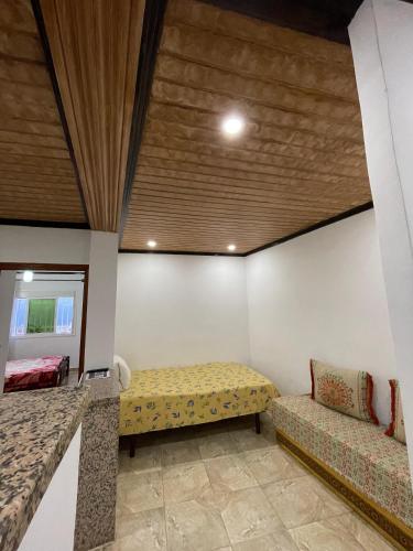 a room with a bed and a couch in it at Casa Abdou in Chefchaouene