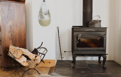 a black stove in a room with a chair at South Main Residences by Surf Hotel in Buena Vista