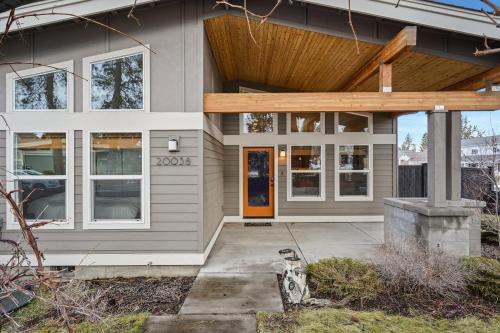 a house with a porch and a wooden roof at Dwell 30 Day Minimum in Bend