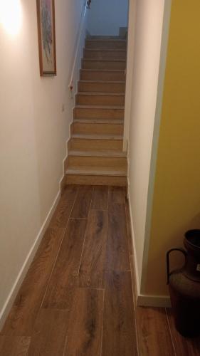 a stairwell with a wooden floor and a stair case at MONDELLO JUNO'S ROOMS in Mondello