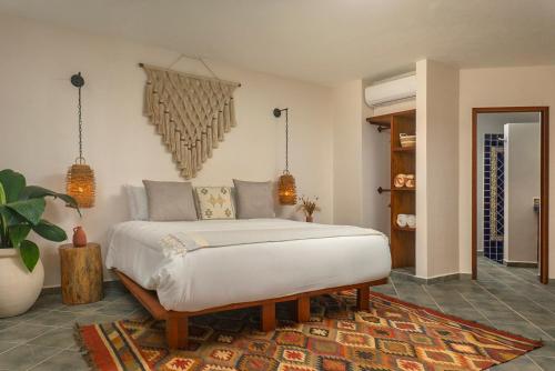a bedroom with a bed in a room at Mantaray Tulum in Tulum
