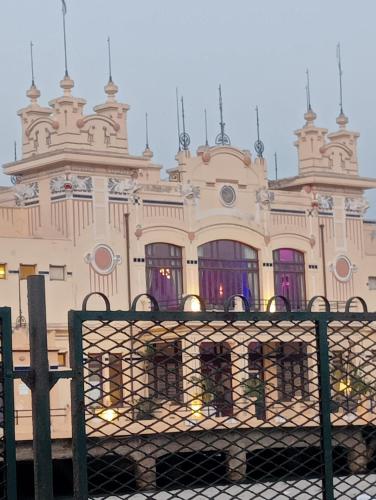 a building with a fence in front of it at MONDELLO JUNO'S ROOMS in Mondello