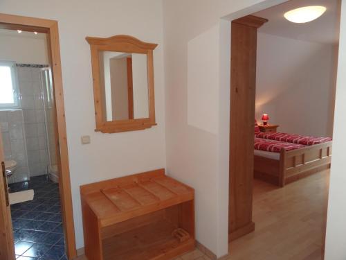 a bathroom with a mirror and a bed in a room at Ferienhaus Zotter in Feldbach