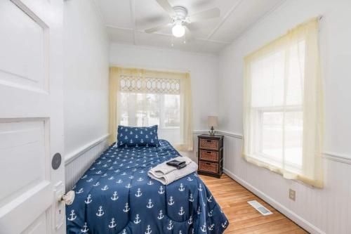 a bedroom with a bed and a ceiling fan at Anchors Away Cottage 5br 10-min Walk To Beach in Old Orchard Beach