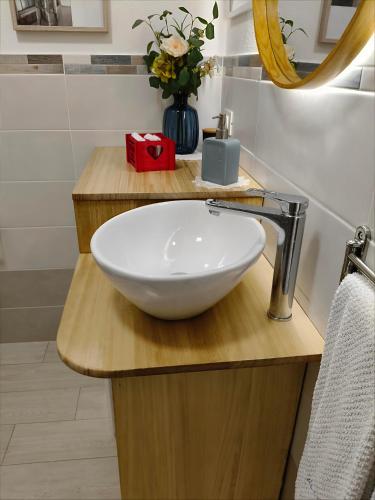 a bathroom with a white bowl sink on a counter at Maison du VALe in Sesta Godano