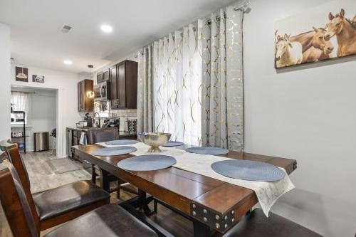 a dining room with a table and a kitchen at Lively Bungalow Retreat Near Belle Isle, RVA! in Richmond