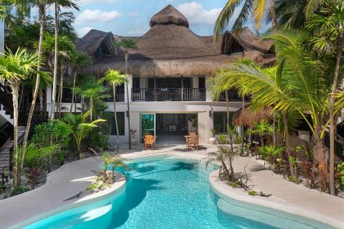 an exterior view of a resort with a swimming pool at Mantaray Tulum in Tulum