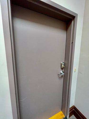a gray door with a silver door knob at Stunning Studio Overlooking Main Street Parkade! in Cedar Falls