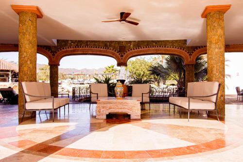 a lobby with chairs and a table and a ceiling at Los Cabos Golf Resort, Trademark Collection by Wyndham in Cabo San Lucas