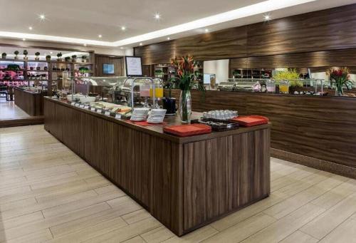 a restaurant with a counter with food on it at S4 Hotel SUÍTE 1120 in Brasilia