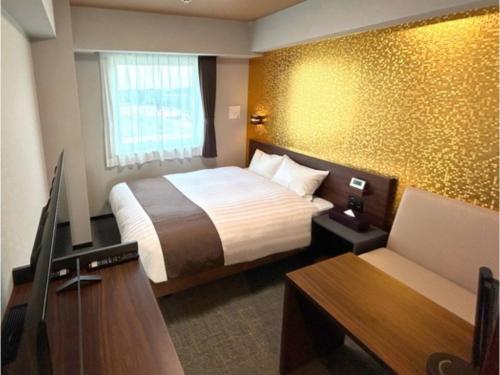 a hotel room with a bed and a flat screen tv at Second Inn Hana Hotel Hanazono Inter - Vacation STAY 40280v in Fukaya