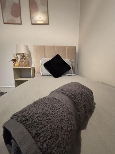 a bed with a black pillow on top of it at Mowbray Retreat in Parkside