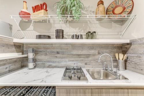 a kitchen counter with a sink and shelves at Georgia Farmhouse Studio with Hiking Trail in Lithonia