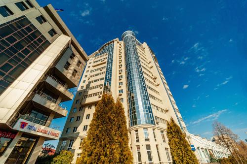 a tall building with a christmas tree in front of it at The Central Collection Apartments in Chişinău