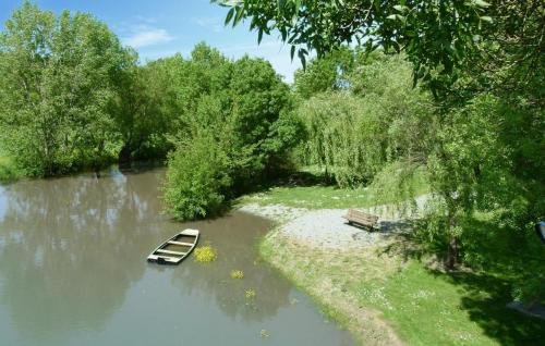 a small boat sitting in the middle of a river at Stunning Home In Egry With Wifi in Égry