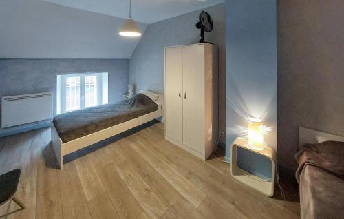 a bedroom with a bed and a cabinet and a tv at Stunning Home In Egry With Wifi in Égry