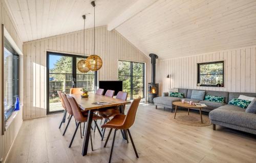 a living room with a table and chairs and a couch at 3 Bedroom Lovely Home In Nexø in Neksø