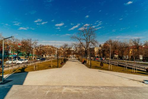 a walkway in a park with cars parked at The Central Collection Apartments in Chişinău