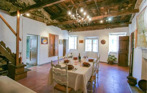 a dining room with a white table and chairs at 3 Bedroom Nice Apartment In Stazzema in Stazzema