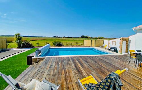 a backyard with a swimming pool and a wooden deck at Villa Avec Piscine Privée in Saint-Jean-de-Monts