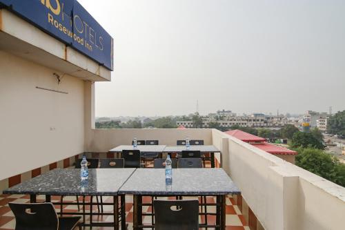a table on a balcony with two water bottles on it at Hotel Rosewood Inn in Amritsar