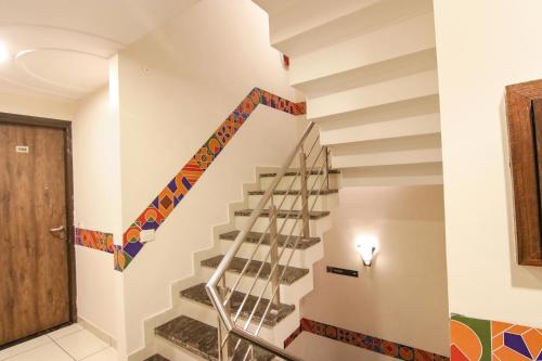 a staircase in a house with colorful tiles on the wall at Hotel Rosewood Inn in Amritsar