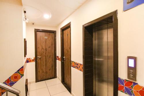 two doors in a room with a staircase at Hotel Rosewood Inn in Amritsar