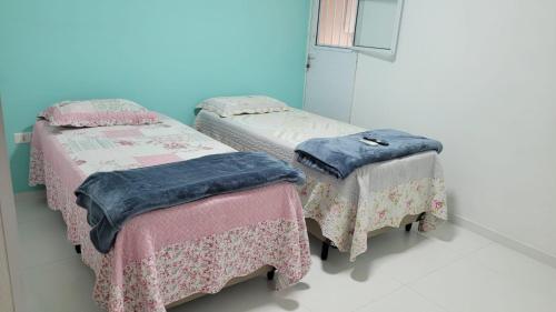 Katil atau katil-katil dalam bilik di Suites Praia de Juquehy