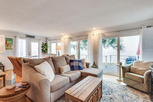 a living room with a couch and a table at Carrabelle Retreat with Boat Dock and Views of Gulf! in Carrabelle