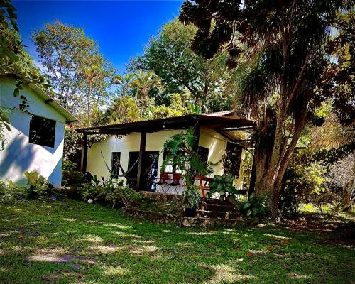 a small house with a tree in the yard at Villa Tayasal in Flores