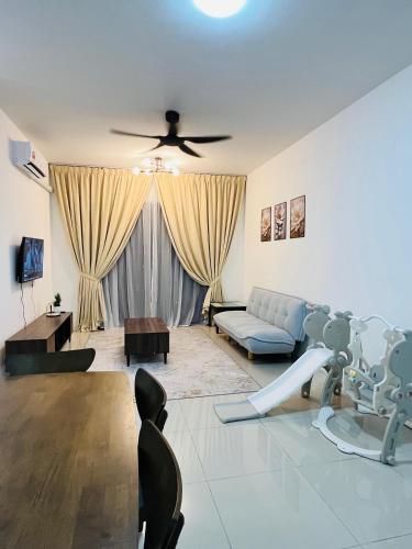 a living room with a couch and a ceiling fan at FA Homestay KLIA 2 in Nilai