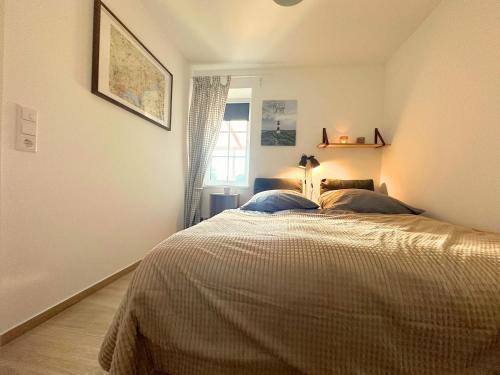 a bedroom with a bed with two pillows on it at Fischerhus in Rieseby