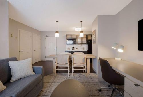 a living room and kitchen with a couch and a table at Sonesta Simply Suites Baltimore BWI Airport in Linthicum Heights