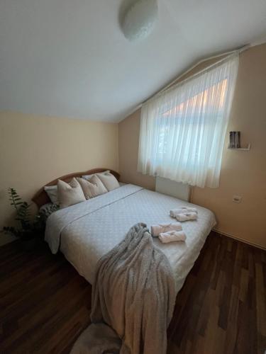 a bedroom with a large bed with two towels on it at Villa Maria in Nižepole