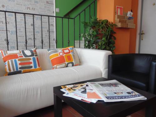 a living room with a white couch and a coffee table at Hostal La Lluna in Arenys de Mar