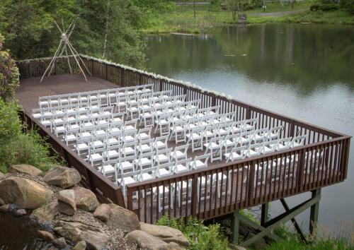 a wooden bridge with rows of white chairs at Chateau Resort & Conference Center in Tannersville