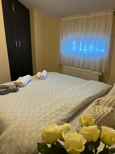 a bedroom with a bed with yellow roses at Villa Maria in Nižepole