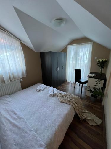 a bedroom with a large bed with towels on it at Villa Maria in Nižepole
