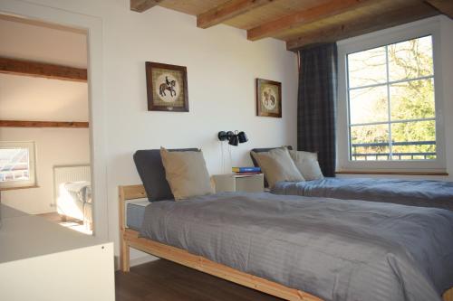 a bedroom with two beds and a window at Fischerhus in Rieseby