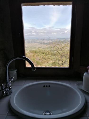 a sink in front of a window with a view at Cantuccio di Val d'Orcia in Campiglia dʼOrcia
