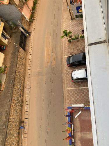 an overhead view of a street with cars parked on the side at Résidence hôtelière MEDOM Palace, Bastos in Yaoundé