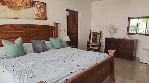 a bedroom with a large bed with green pillows at the million view room habitacion en resort solo adultos in La Laguna