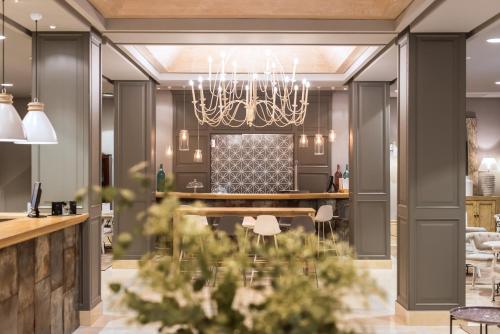 a dining room with a table and a chandelier at Vincci Lys in Valencia